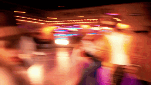 a blurry photo of people dancing in a room