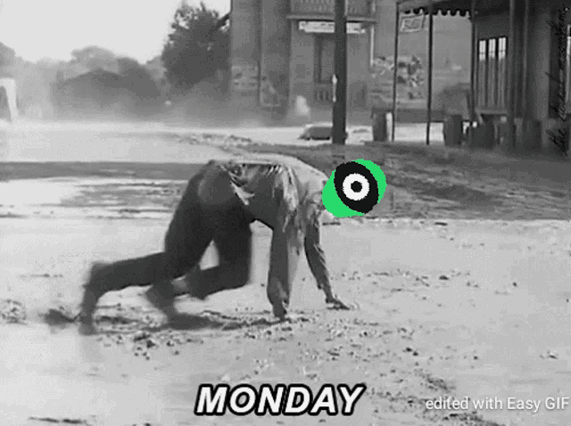 a black and white photo of a man crawling in the dirt with the words monday edited with easy gif