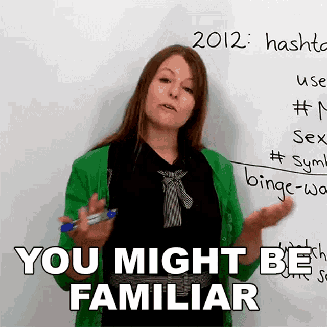 a woman stands in front of a white board that says 2012 hash and says you might be familiar