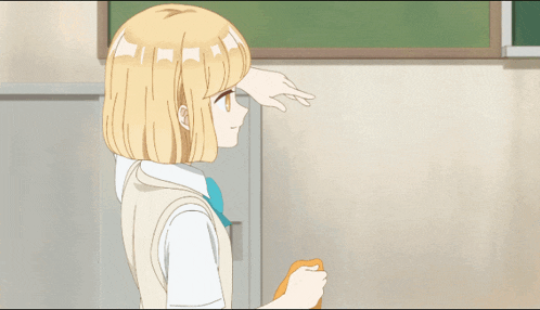 a girl with blonde hair is standing in front of a green chalkboard