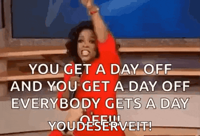 oprah winfrey is giving a speech on a stage while holding a microphone and raising her arms in the air .