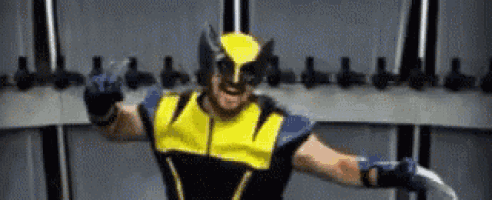 a man in a wolverine costume is standing in a locker room .