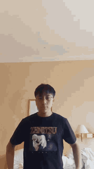 a young man wearing a zenitsu shirt is standing in a bedroom