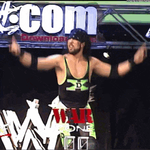 a wrestler is standing in front of a sign that says war one