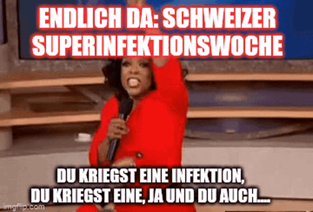 a woman in a red jacket is holding a microphone in front of a sign that says endlich da schweizer superinfektionswoche