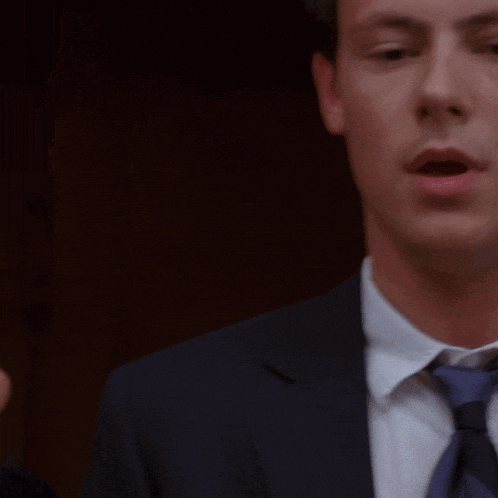 a man in a suit and tie with his mouth wide open