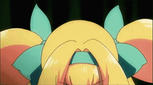 a close up of a cartoon character 's face with a blue bow in her hair