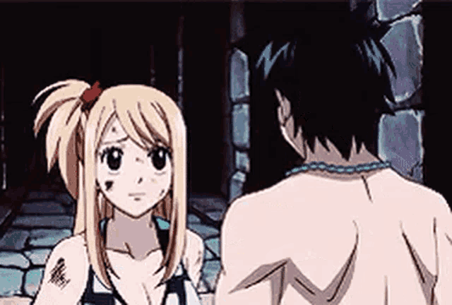 a man and a woman are standing next to each other in a dark room and talking to each other .