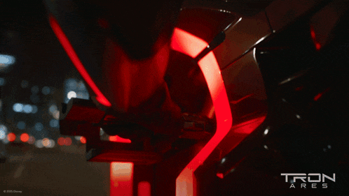 a poster for tron ares shows a motorcycle wheel