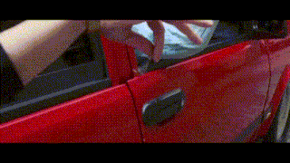 a person is trying to open a red car door