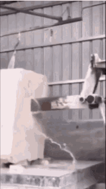 a machine is cutting a piece of ice in a factory