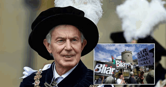 a man in a black hat holds a sign that says ' blair ' on it