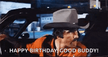 a man in a cowboy hat is driving a car and saying `` happy birthday , good buddy '' .