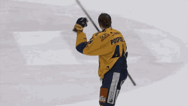 a hockey player wearing a yellow jersey with the number 44 on the back