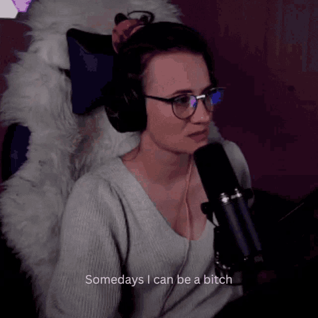 a woman wearing headphones and glasses says somedays i can be a bitch in front of a microphone