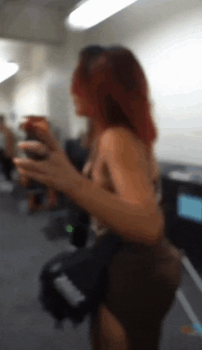 a blurry picture of a woman with red hair in a room