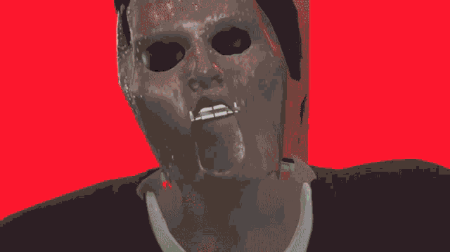 a man with a mask on his face is blowing bubbles