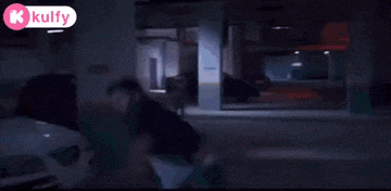 a man is fighting another man in a hallway in a building .