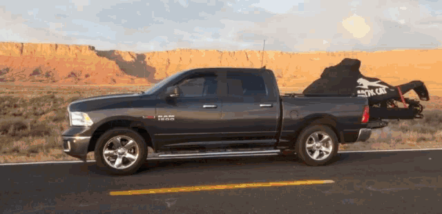 a black dodge ram truck is parked on the side of the road