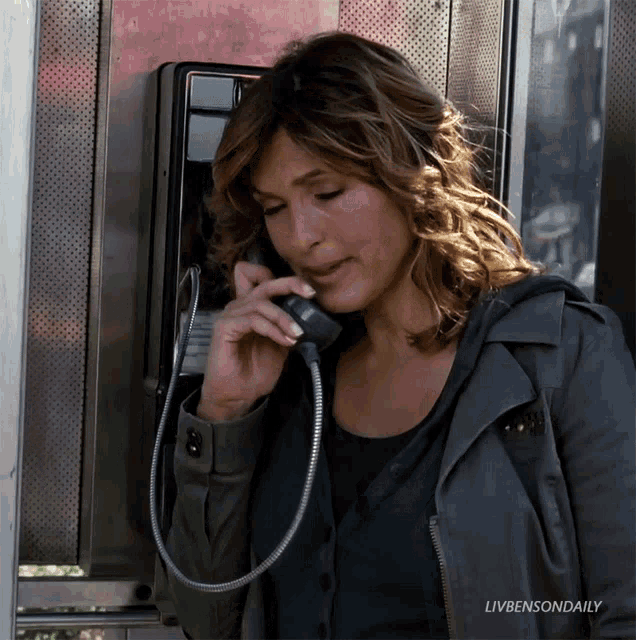 a woman is talking on a pay phone with livbensondaily written on the bottom of the image