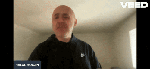 a man in a black nike shirt is talking on a video call
