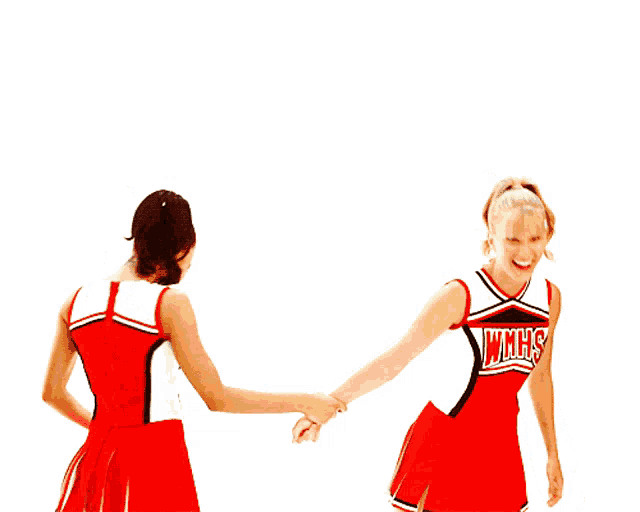 two cheerleaders wearing red uniforms with whhs written on them shake hands