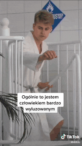 a man in a bathrobe is standing on a set of stairs with a sign behind him that says us wet