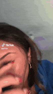 a close up of a woman 's face with a tiktok watermark