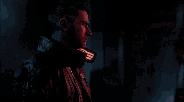 a man in a samurai jacket talks to another man in a room