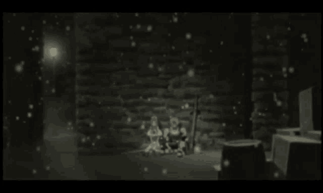 a couple of people sitting in a dark room with snow falling around them