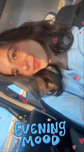a woman is sitting in a car with the words evening mood on the screen