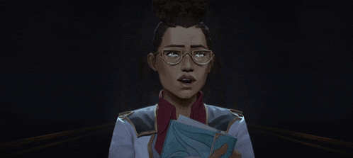 a woman wearing glasses is holding a book in her hands