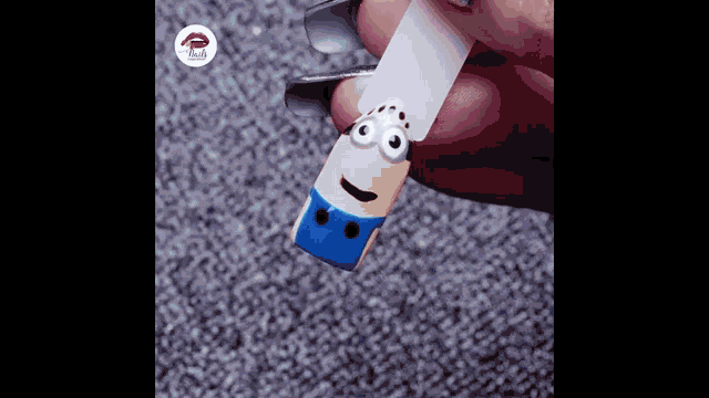 a person is holding a piece of paper that looks like a minion .