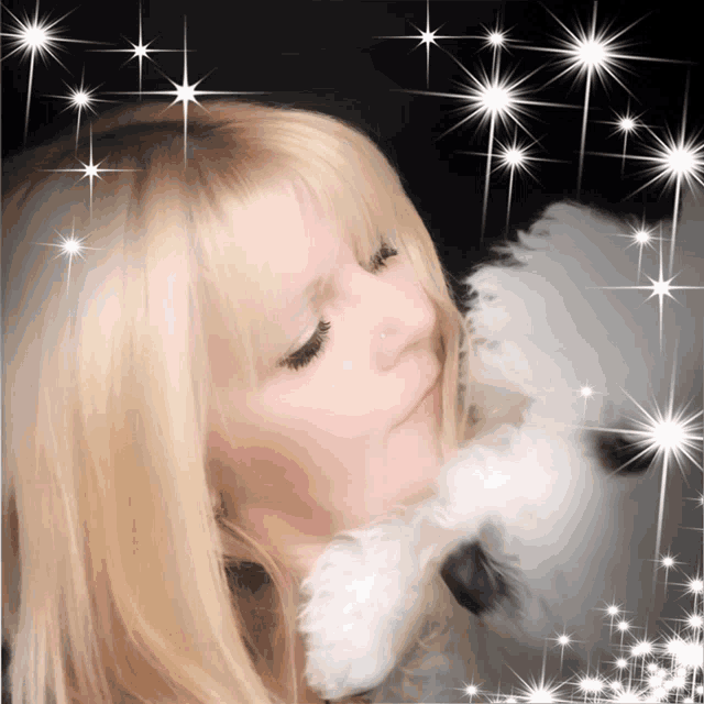 a woman with blonde hair is holding a stuffed animal in front of a starry background
