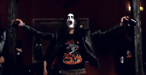 a man in a black leather jacket has a coca cola logo on his chest