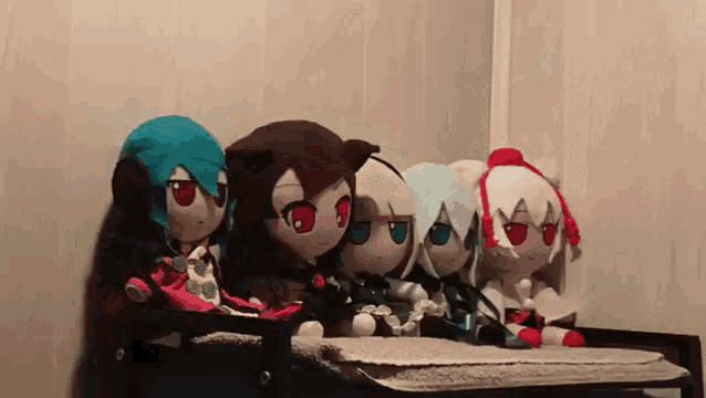 a group of stuffed animals are sitting on a shelf in a room .