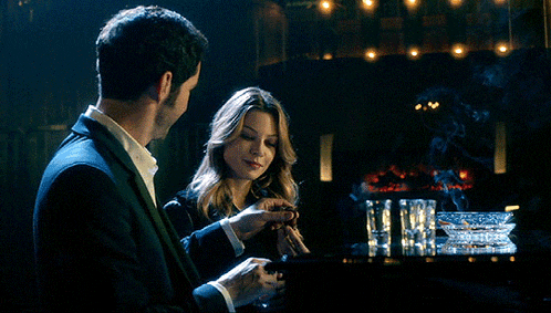 a man and a woman are sitting at a table with ashtrays on it