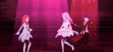 three anime girls are dancing on a stage .