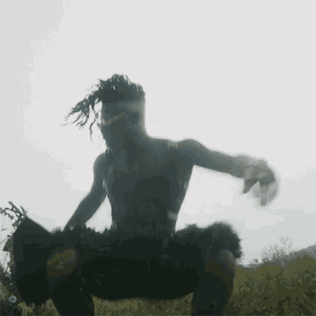a man with dreadlocks is dancing in the air