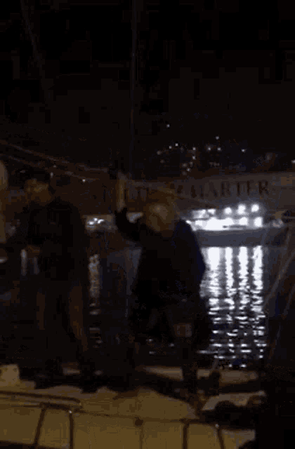 a group of people are standing on a boat in the water with a sign that says ' ruta ' on it