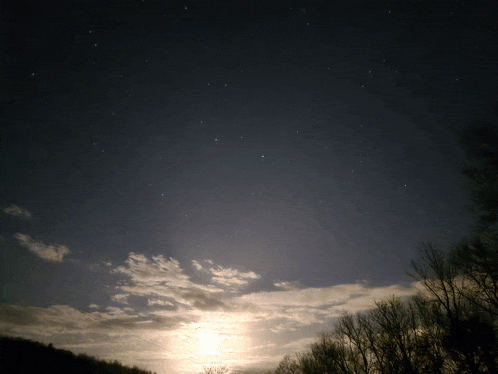 the sun is shining through the clouds in a dark sky