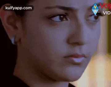 a close up of a woman 's face with the words kulfyapp.com at the bottom