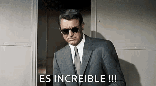 a man in a suit and tie is wearing sunglasses and saying es increible