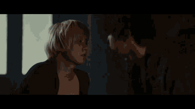 a man and a woman kissing in the dark