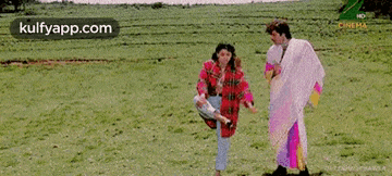 a man and a woman are standing in a field .