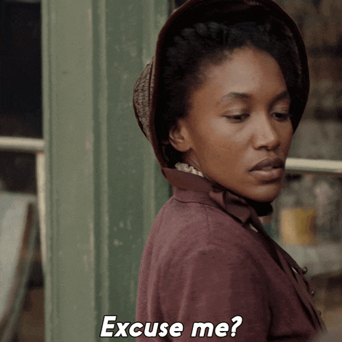 a woman wearing a hat says " excuse me " in white letters