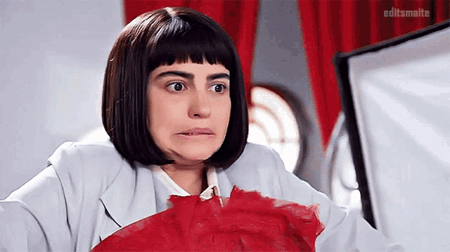 a woman wearing a wig and a white jacket with editsmaite written on the bottom left