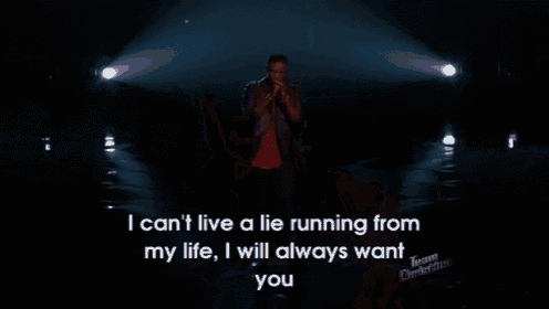 a man singing into a microphone with the words i can t live a lie running from my life