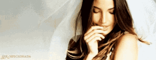 a woman covering her mouth with her hand and the words gif4ficinada on the bottom right