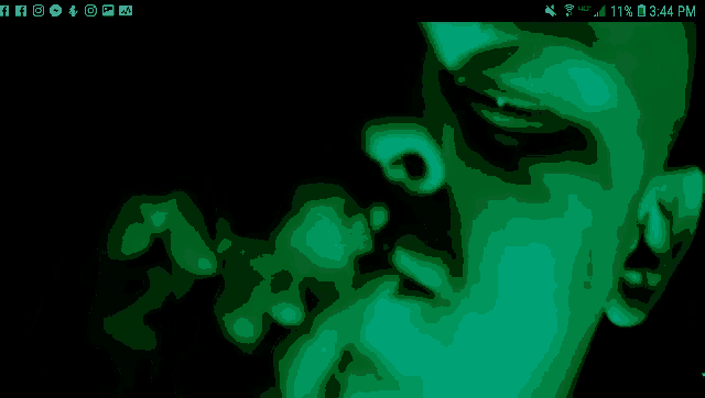 a phone screen shows a man smoking a cigarette and the time is 3:44